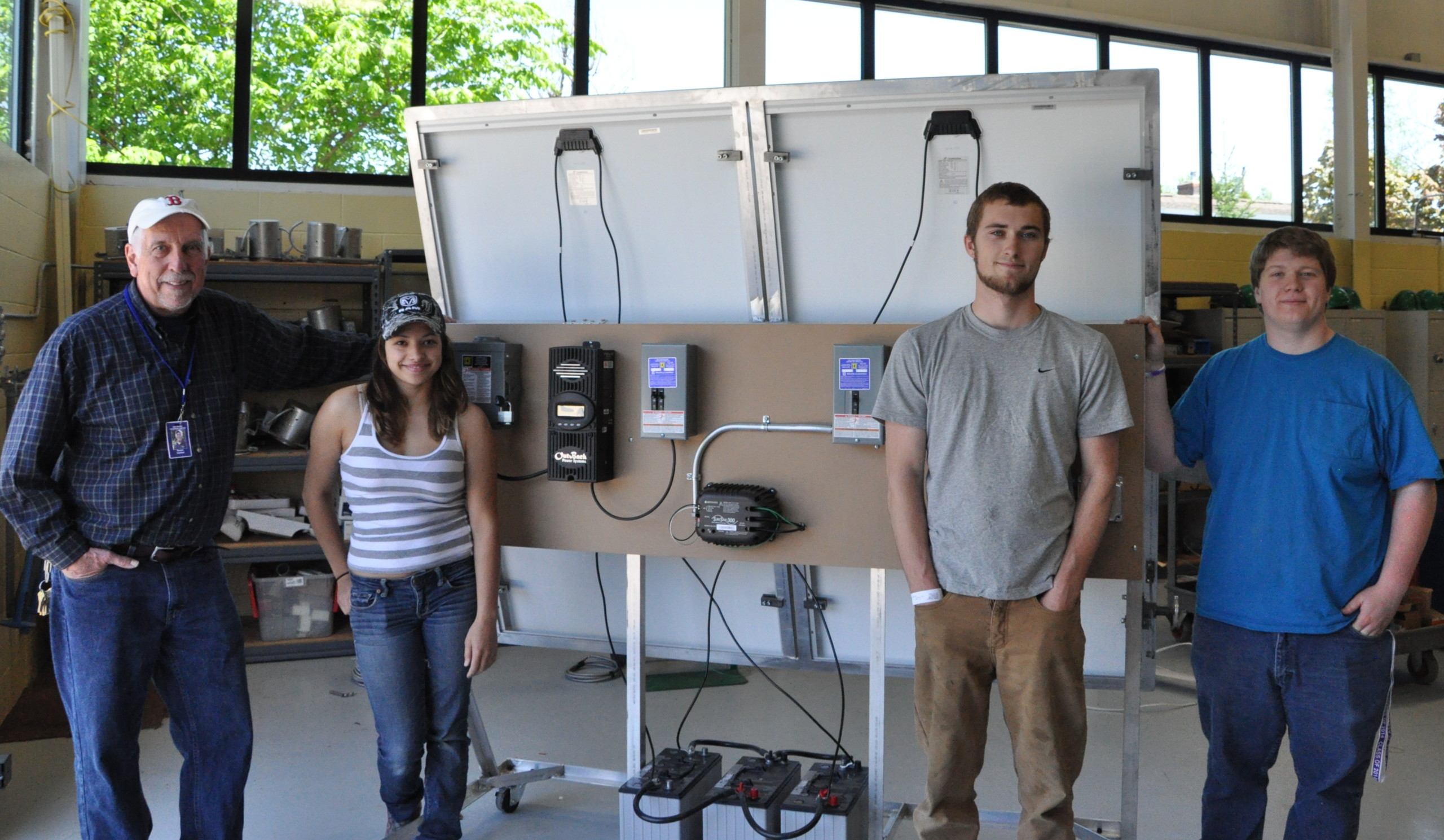 Keven Vachon and MMTC electrical students with the solar training unit they built